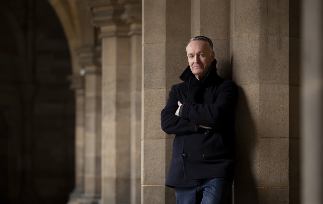 Andrew O'Hagan in the University of Glasgow's cloisters. Photo credit Martin Shields